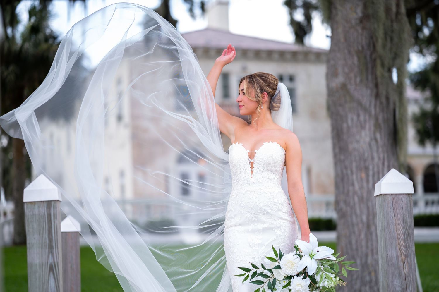 Bridal portraits of the bride tossing her veil during the bridal portrait session.