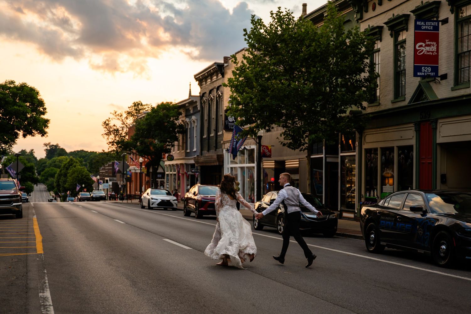 Bride and groom cross a small-town street in shelbyville, Kentucky at The Gatsby on Main.