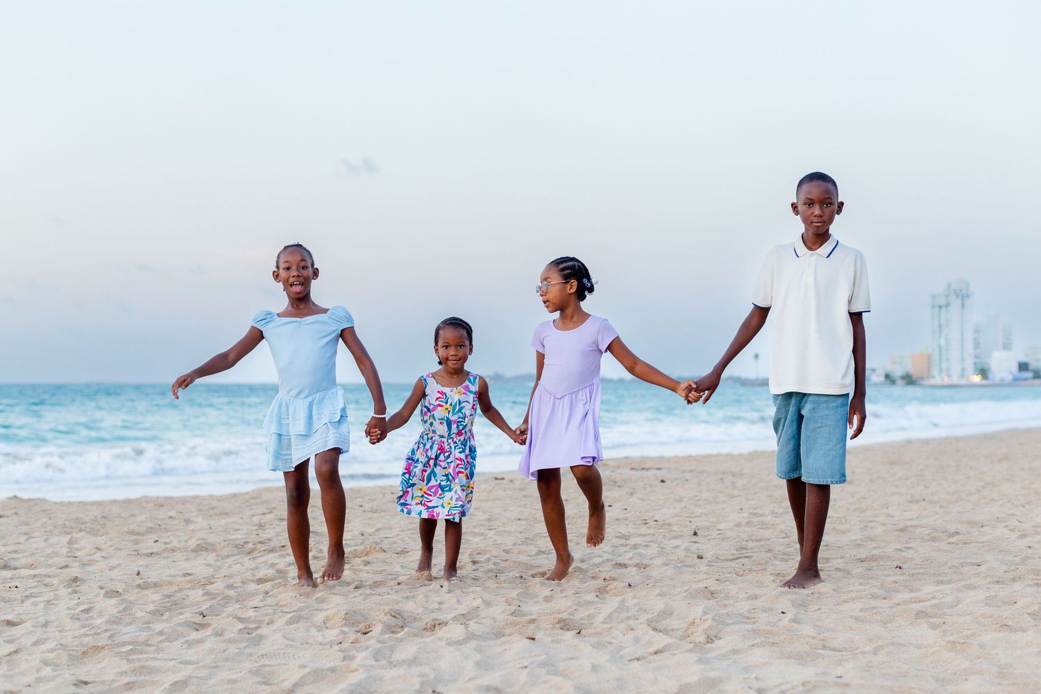 Kids portrait. Four kids holding hands on the beach in Isla Verde, Carolina, Puerto Rico.