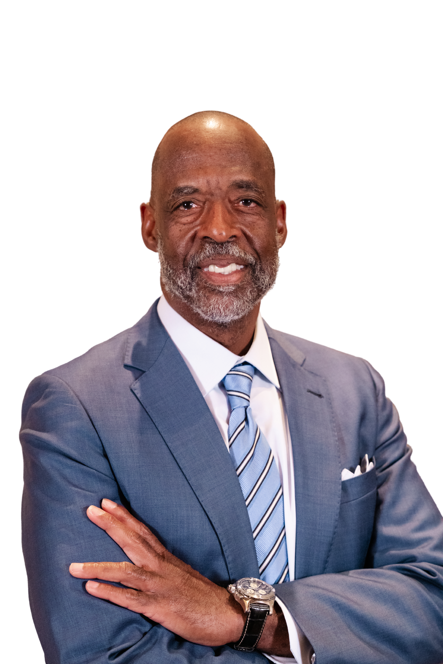 Professional businessman in blue suit and striped tie, arms crossed, smiling confidently against white background.