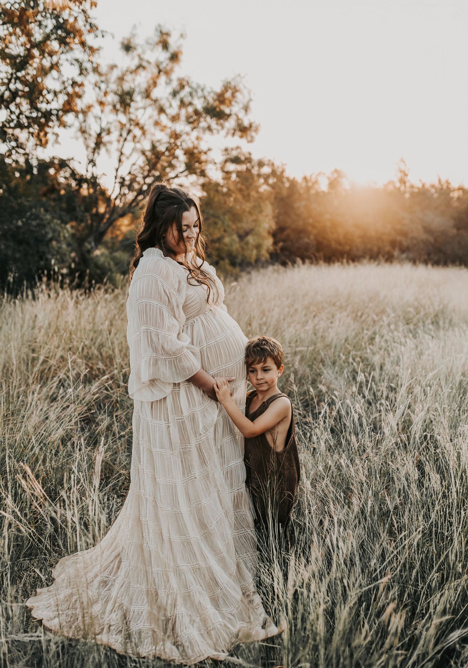 Dallas family photographer capturing playful moments during an outdoor maternity session