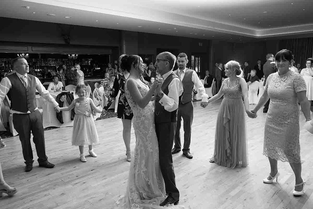 Black and white wedding reception photo of the bride and her father sharing the second dance at Greenhill Hotel Wigton