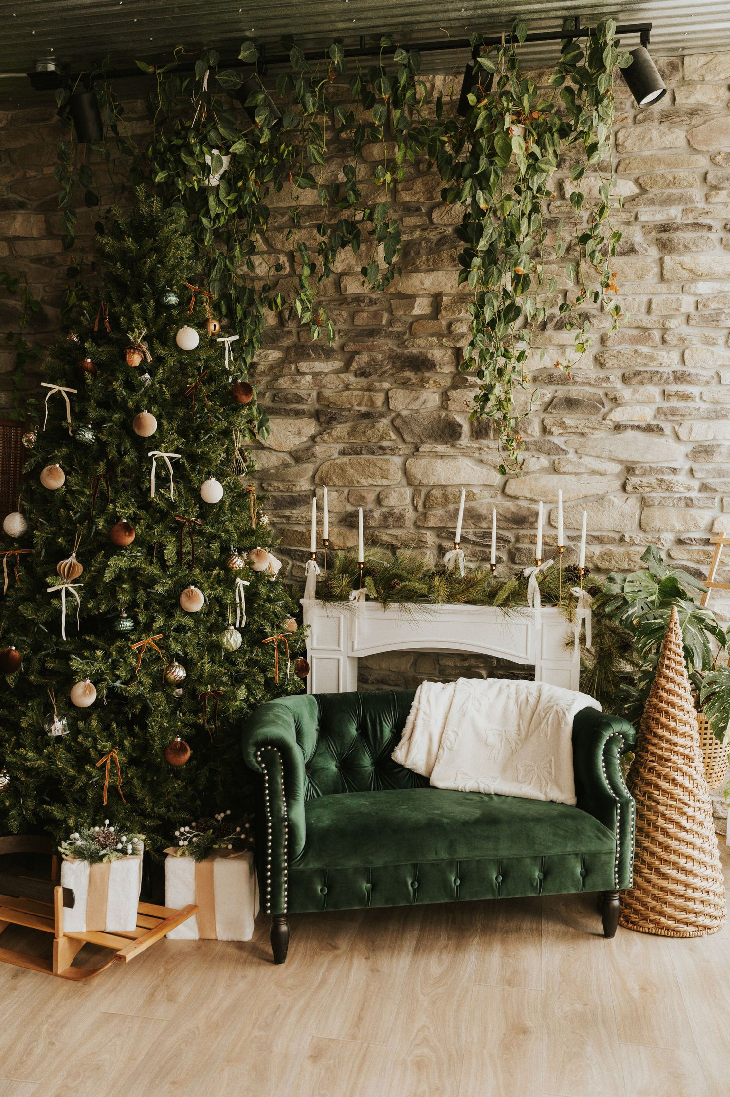 White chair with green blanket against red curtains adorned with three Christmas wreaths on black and white checkered floor.
