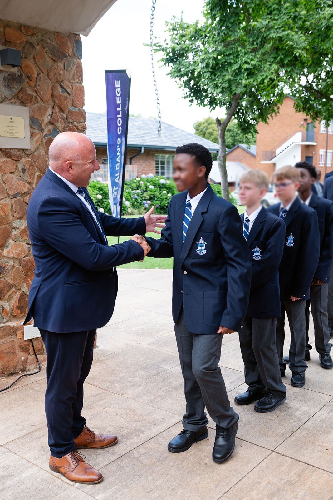 School learners ringing the school bell at their Grade 8 welcoming ceremony.
