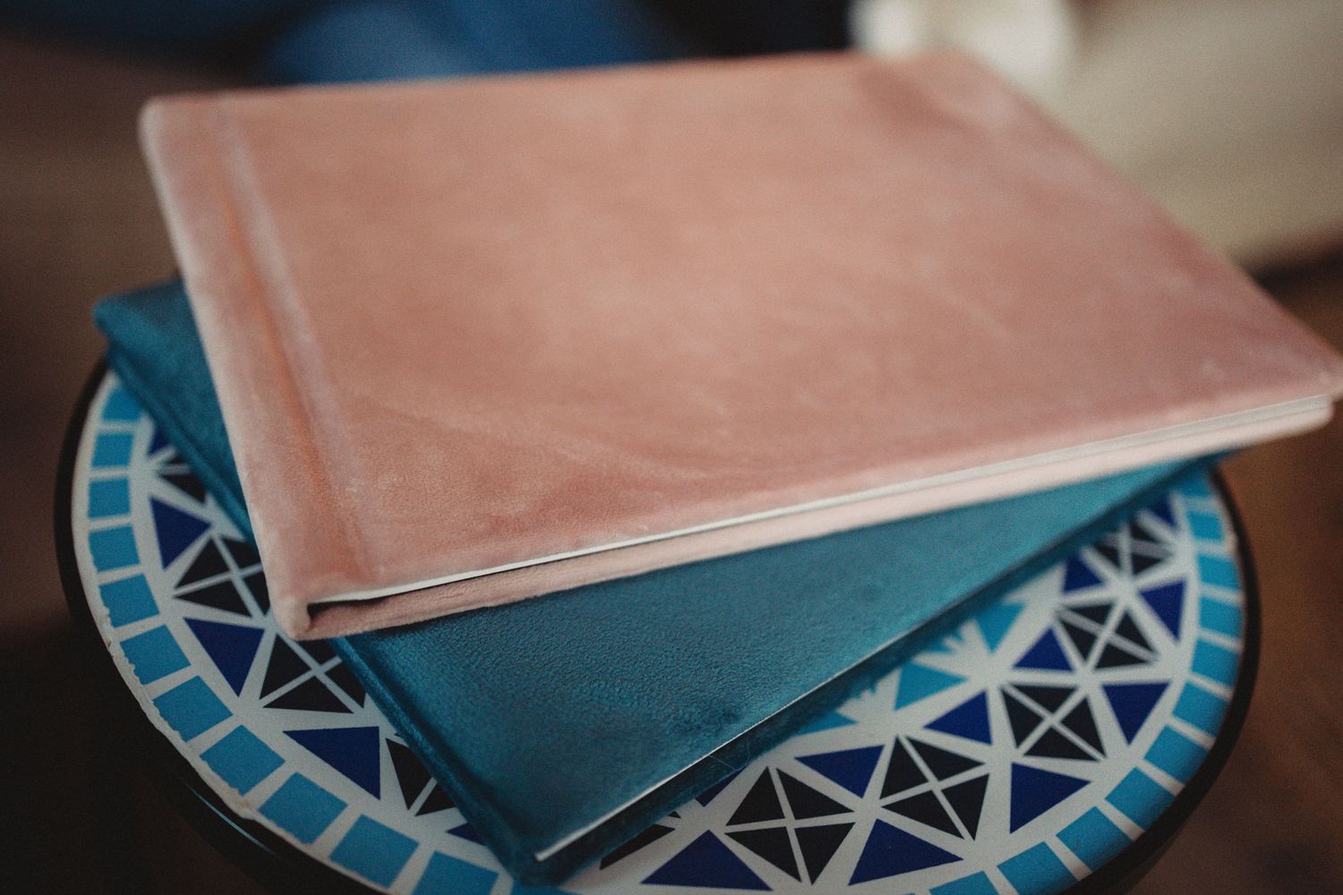 Detail shot of photo album pages spread open on wooden table.
