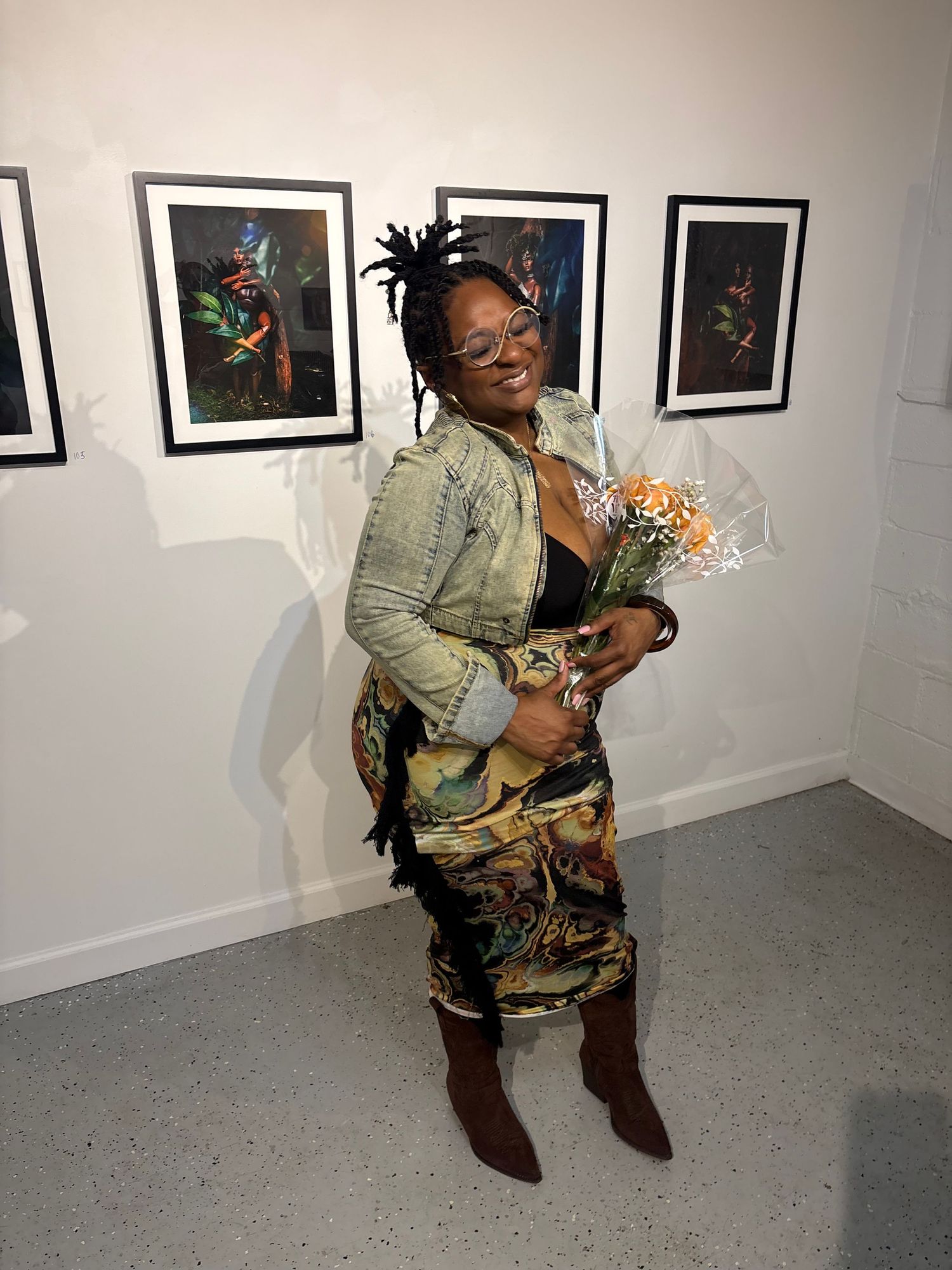 Venus Wright holding flowers at Black Women With Cameras exhibition.