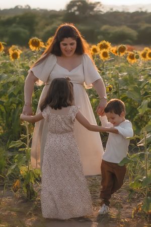 Dancing and playing together in a sunflower field during a warm summer evening photoshoot in the Hudson Valley,NY.
