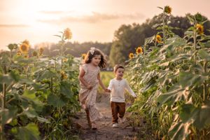 A joyful moment captured while walking through tall sunflowers during golden hour in the Hudson Valley,NY.
