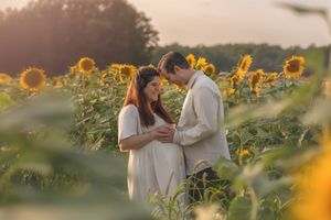 An intimate moment shared between a couple in a sunflower field at sunset in the Hudson Valley,NY.