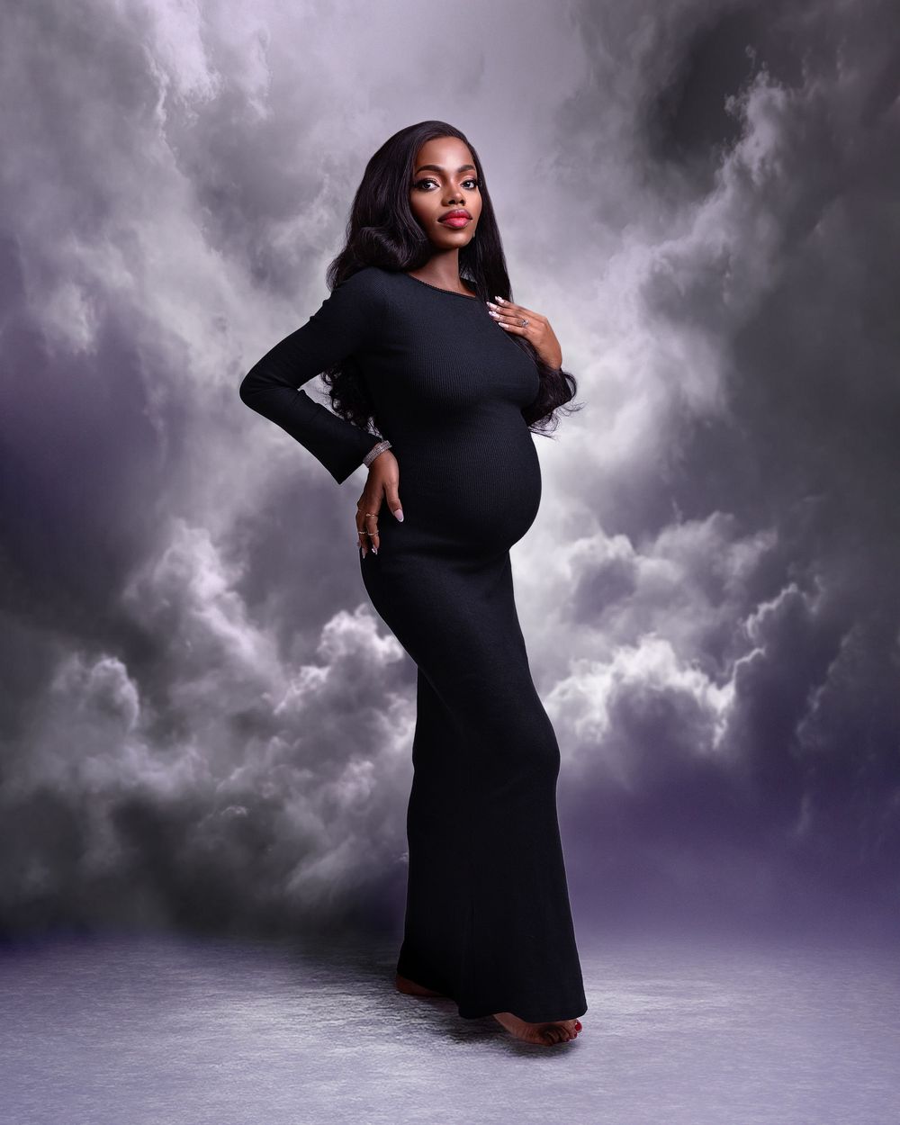 pregnant woman in black dress studio portrait