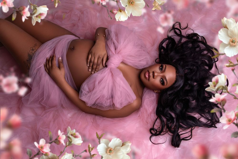 Pregnant woman in a light fabric holding baby bump, studio session in Wolverhampton