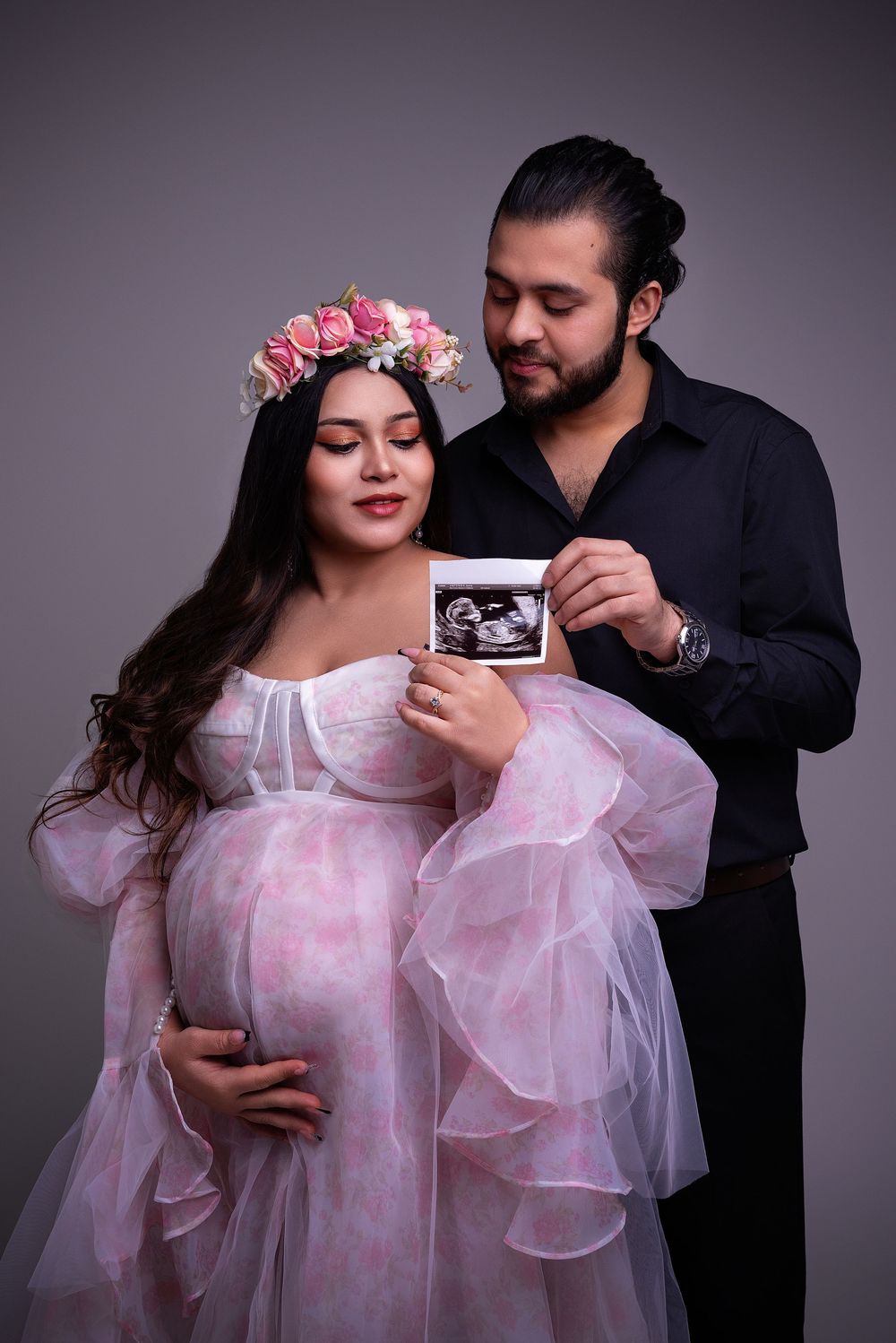 couple holding a scan photo during maternity session Birmingham