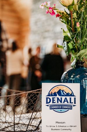 Denali Chamber of Commerce sign with blue vase of flowers.