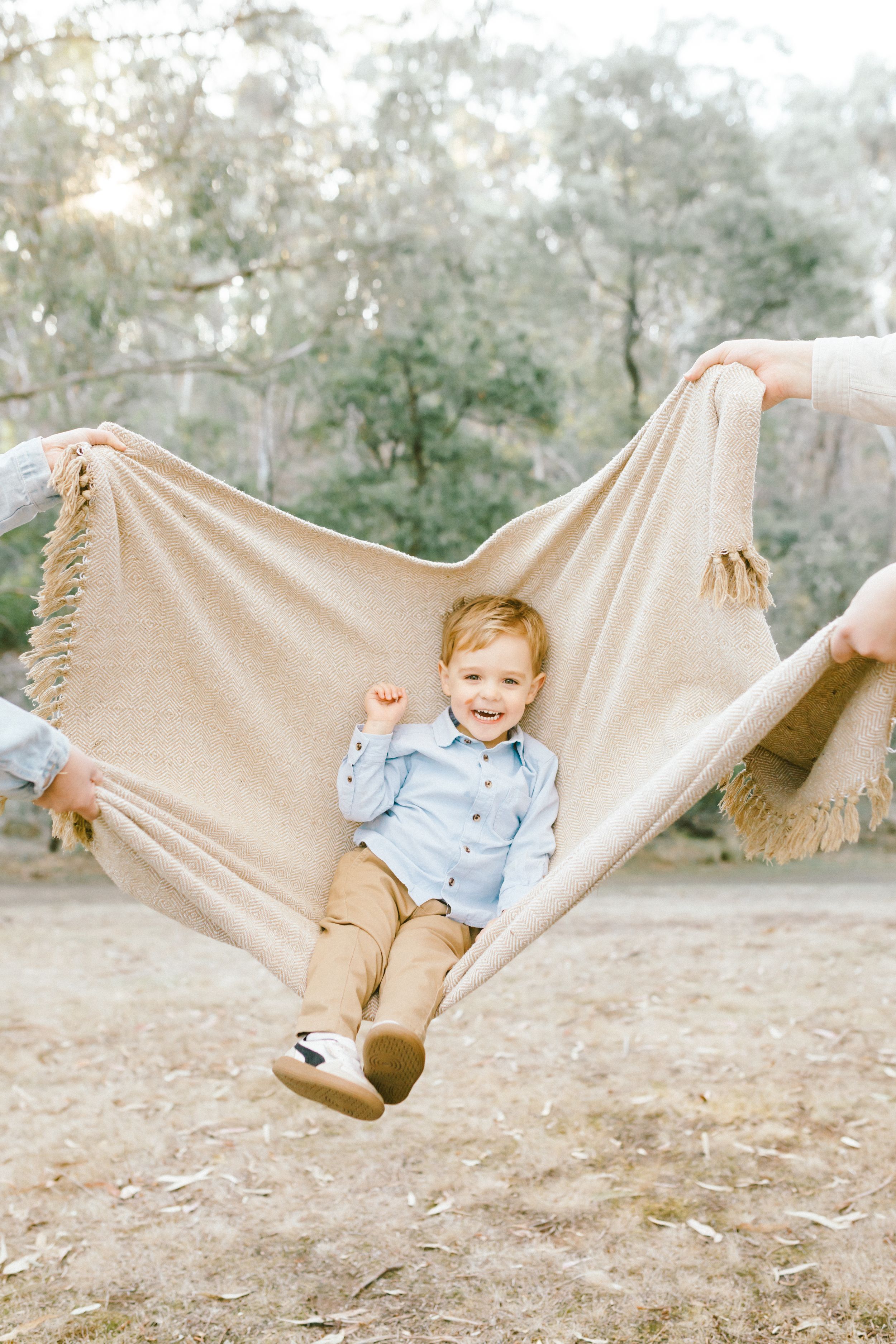 A sequence of photos showing a child swinging in a beige hammock outdoors among trees.
