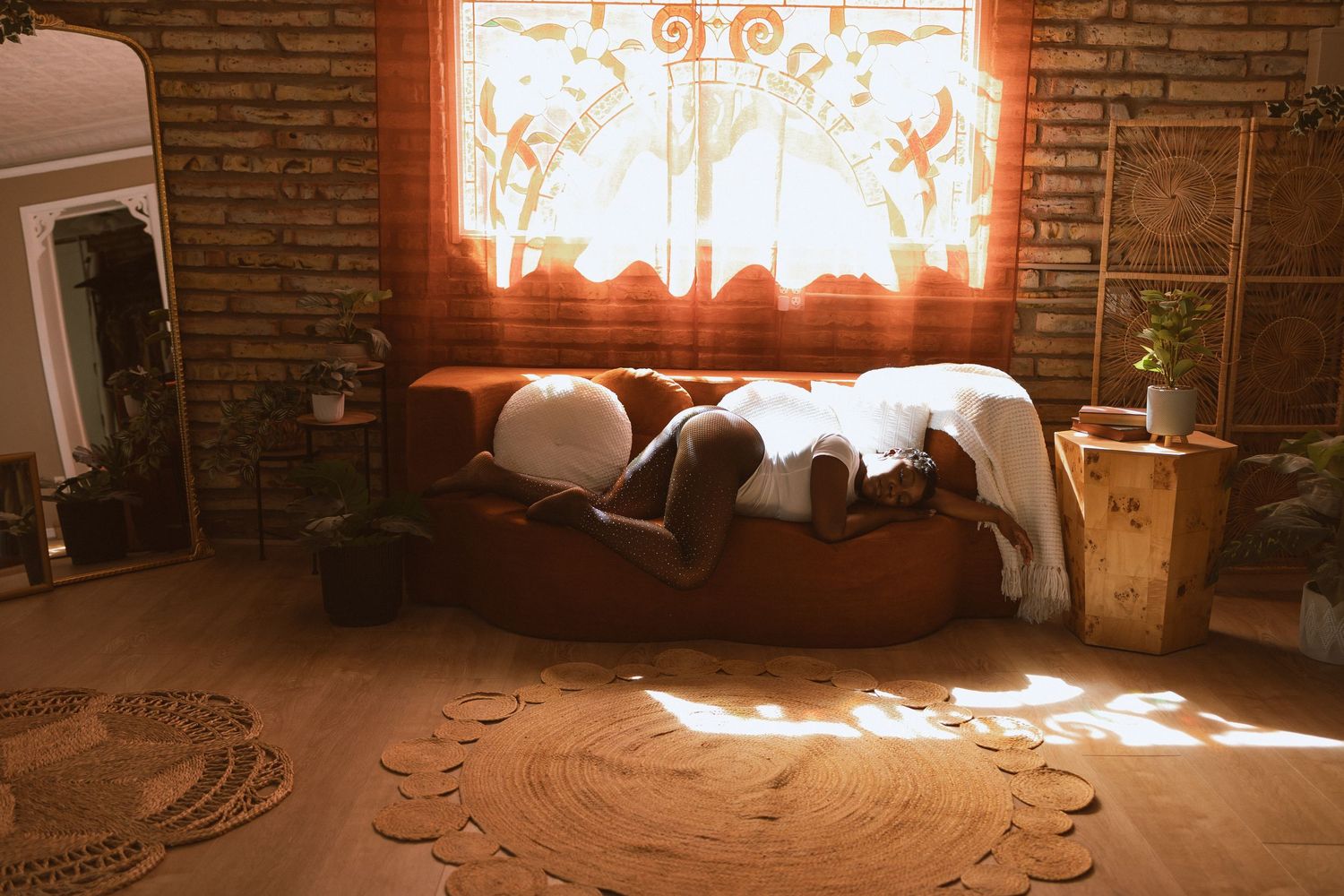 A series of connected photos showing a sunlit room with brick walls and natural light streaming through windows.