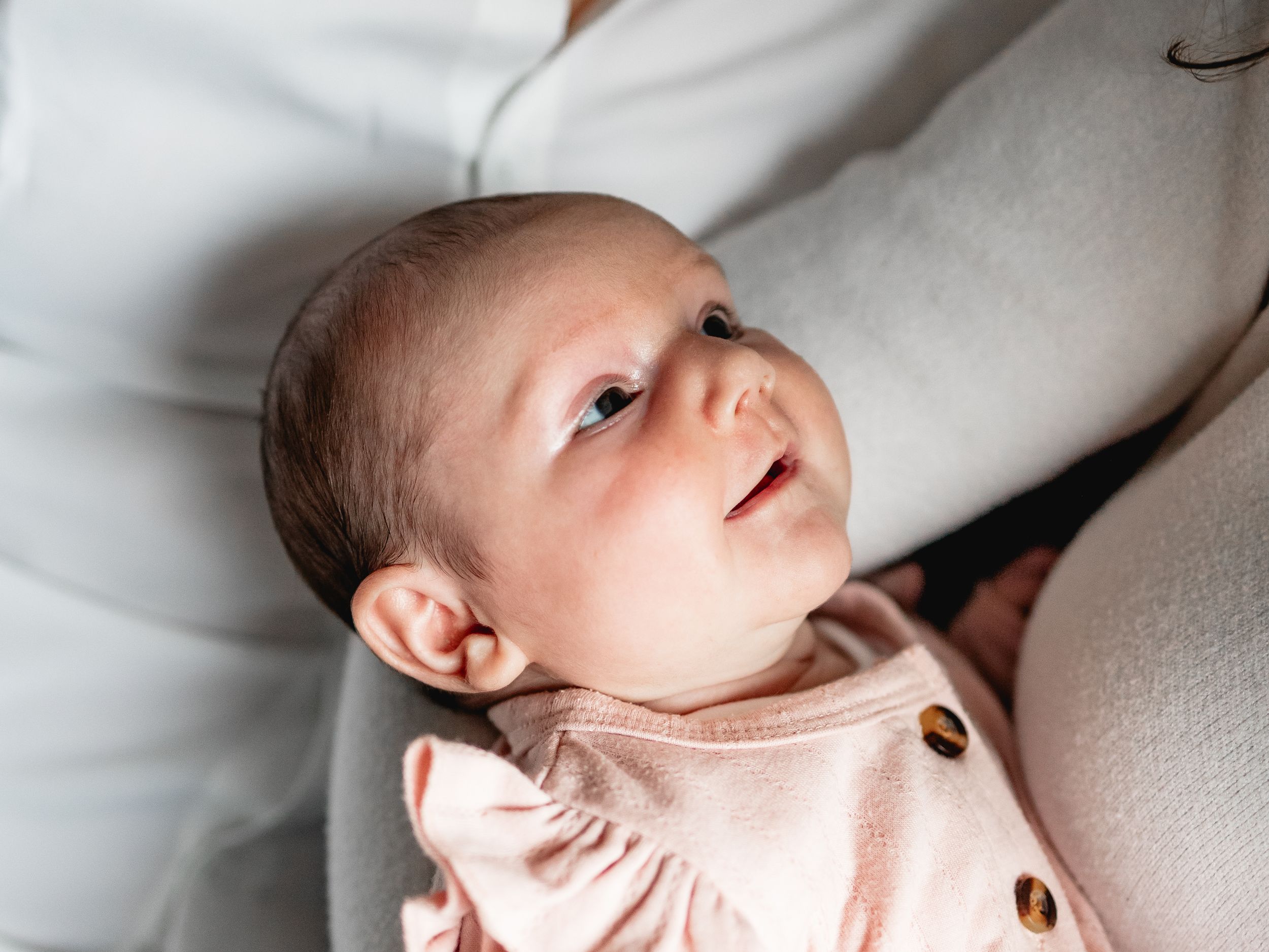 Series of gentle newborn baby portraits in soft natural light.