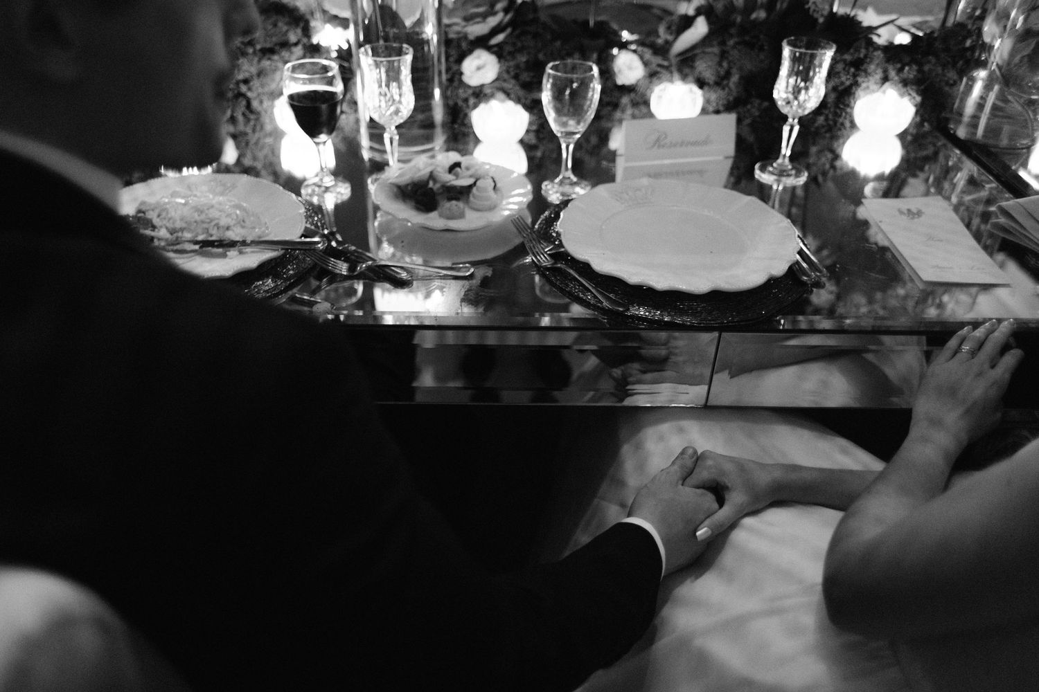 Close up of couple holding yellow drinks at their wedding reception.