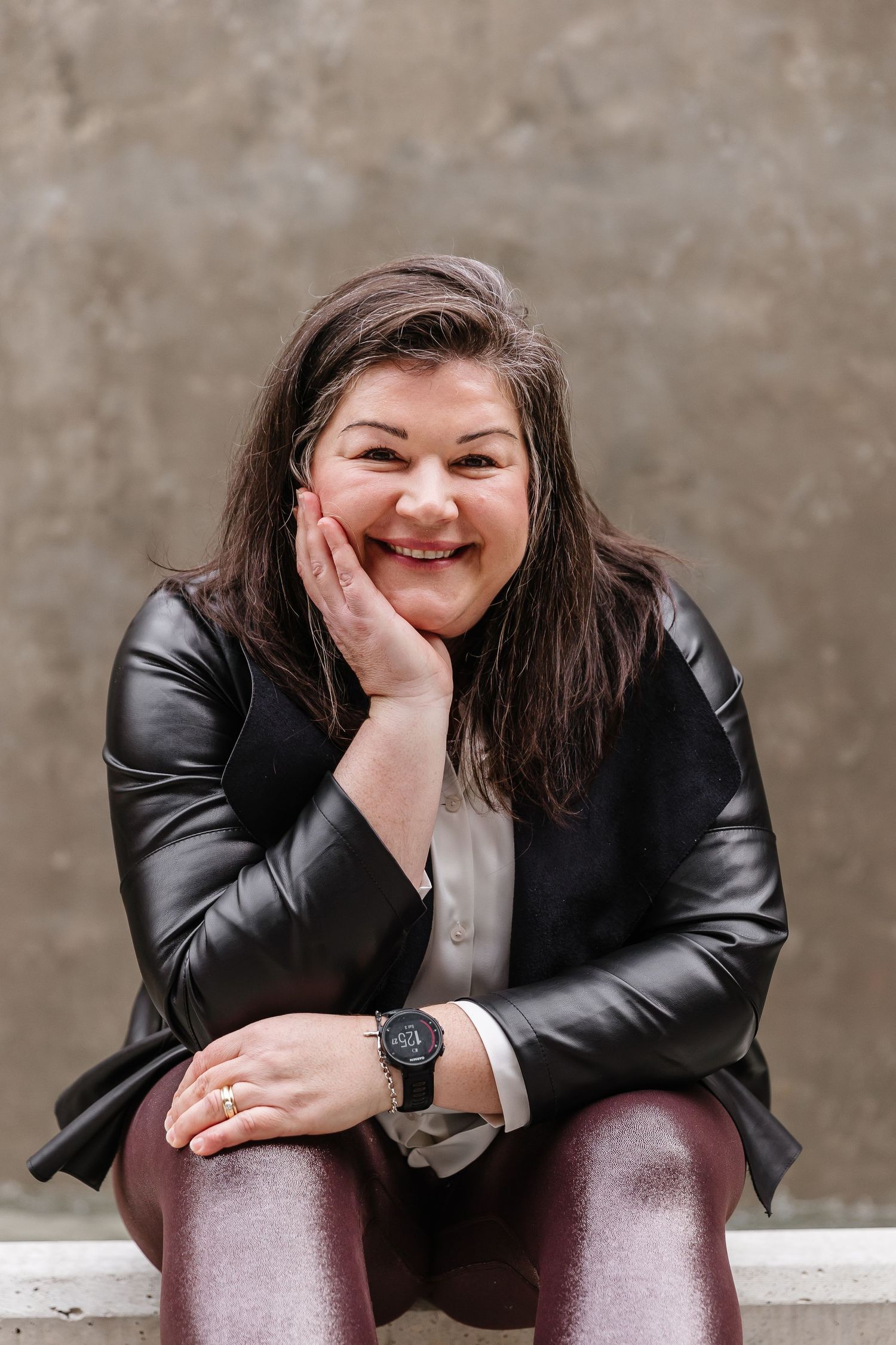 Portrait series showing joyful expressions while wearing a black leather jacket.