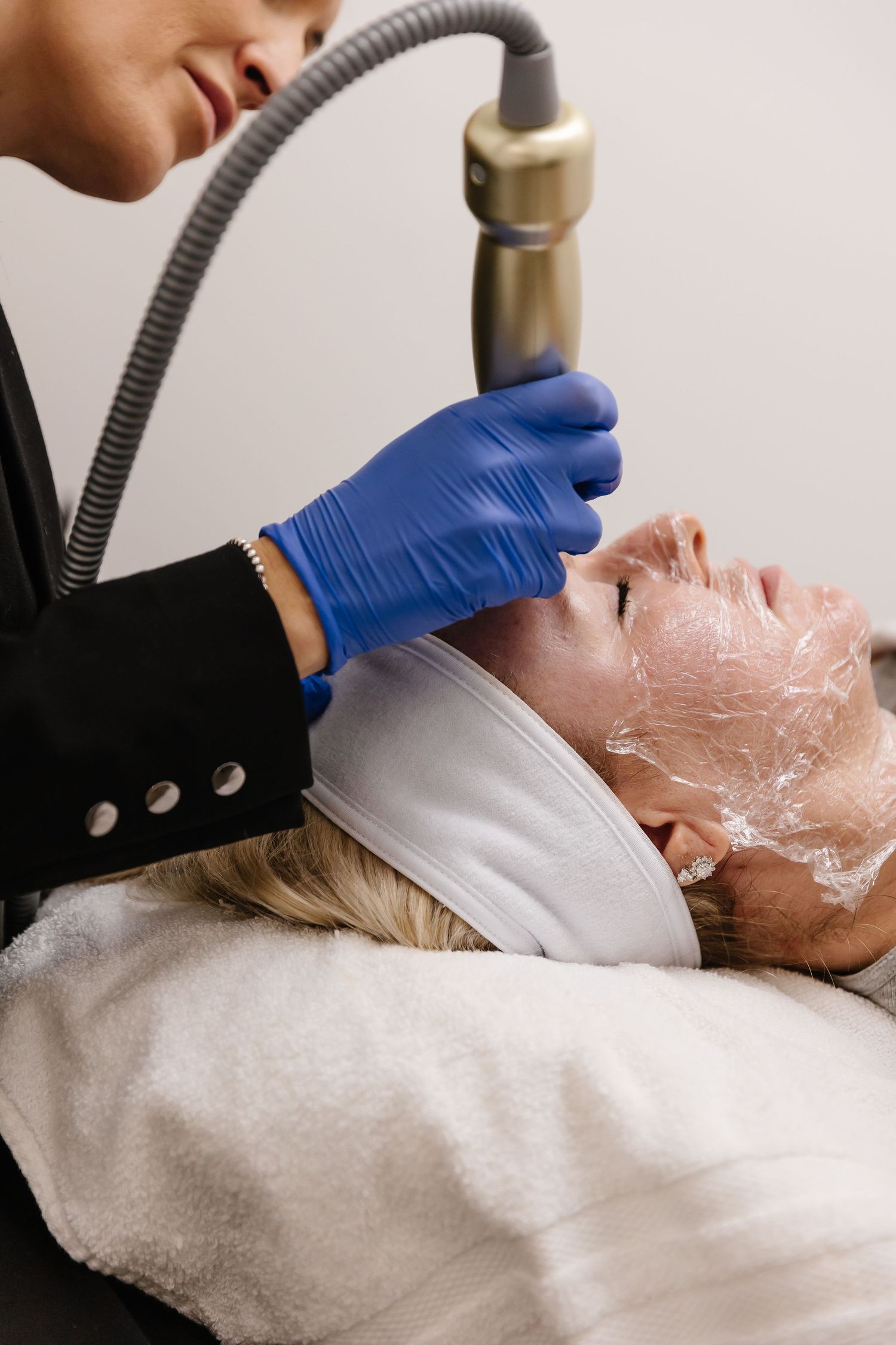 A series of images showing a facial treatment procedure with blue gloved hands using professional skincare equipment.