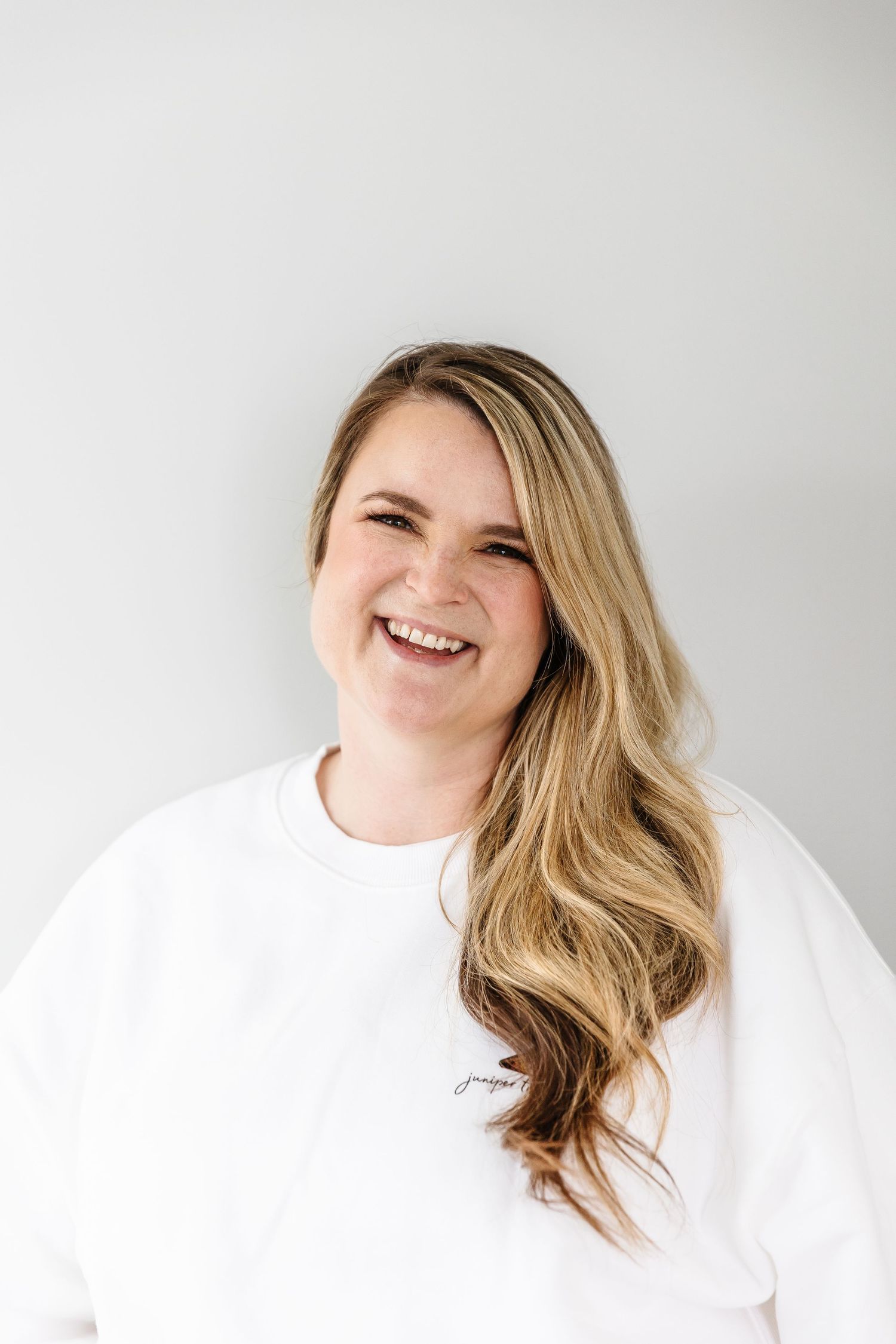 Portrait against white background showing joyful expression.