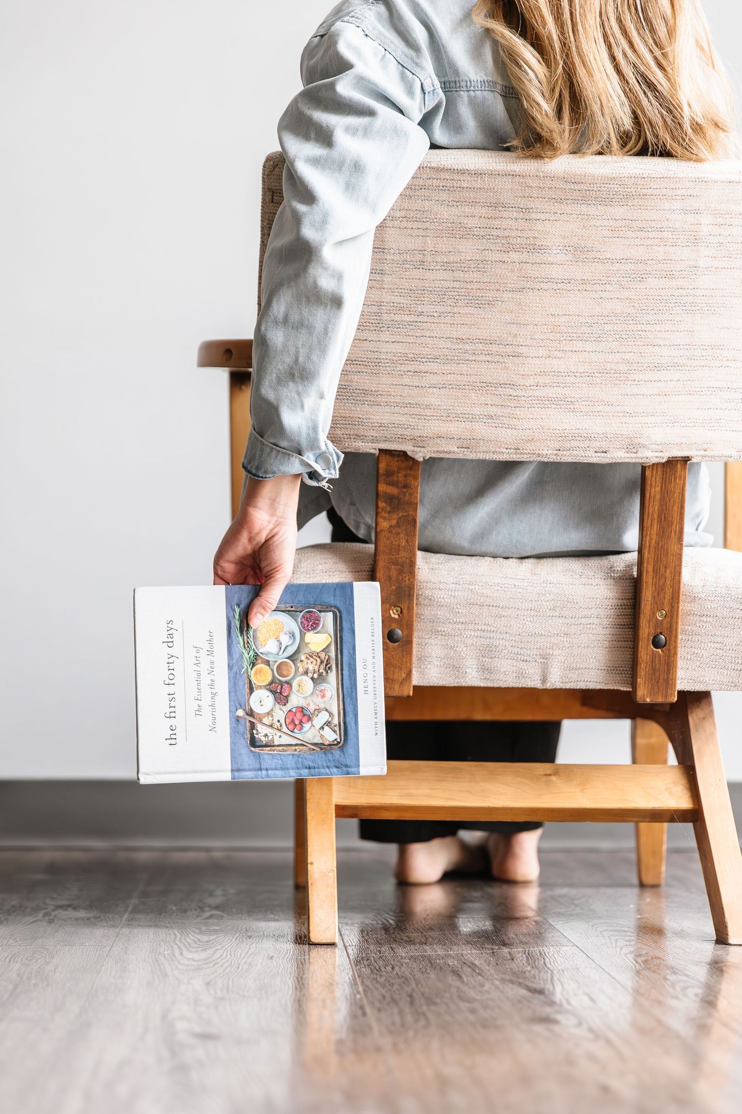 A series of photos showing someone sitting on a wooden bench while holding a book at different angles.