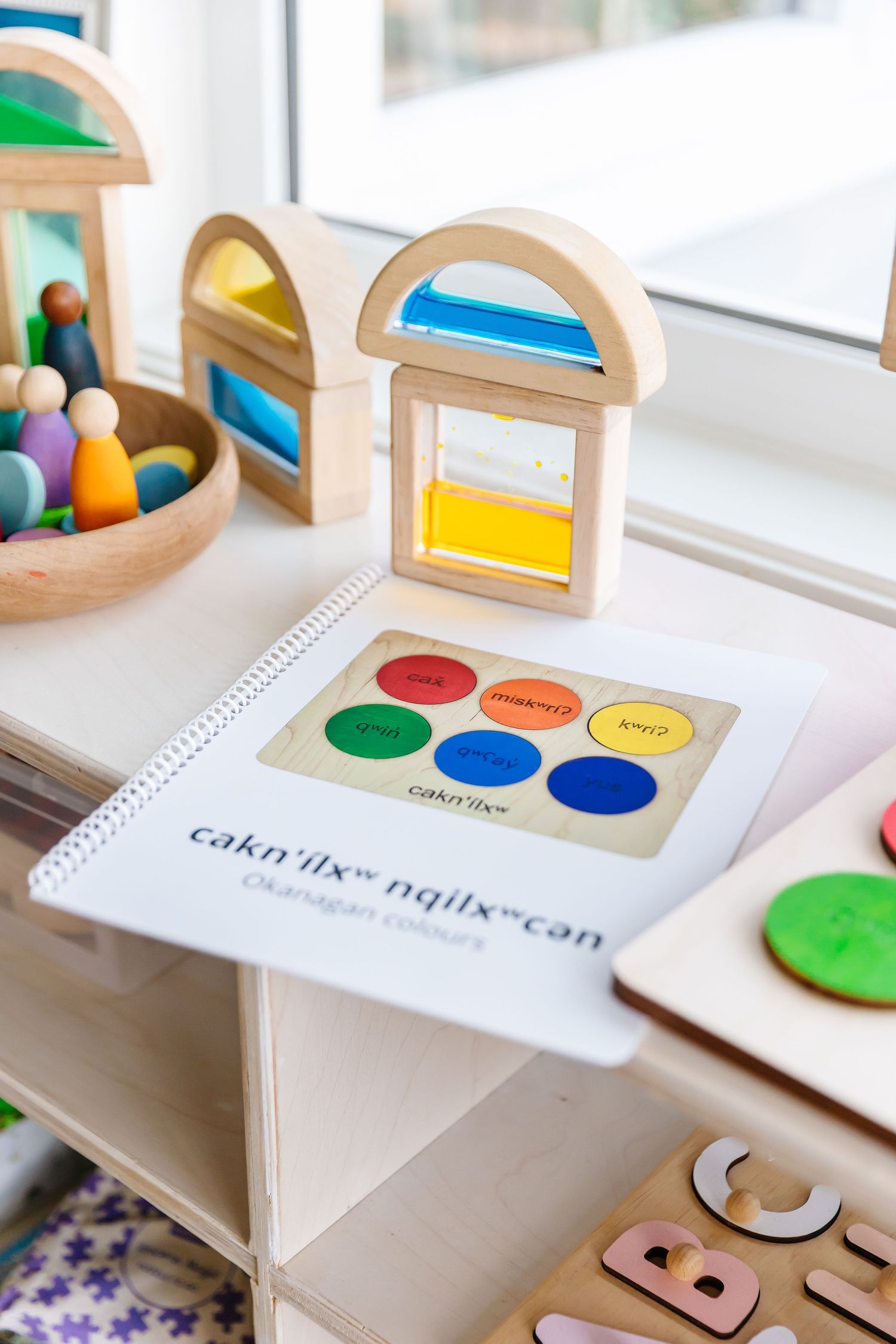Colorful wooden educational toys and learning materials displayed on white surface.