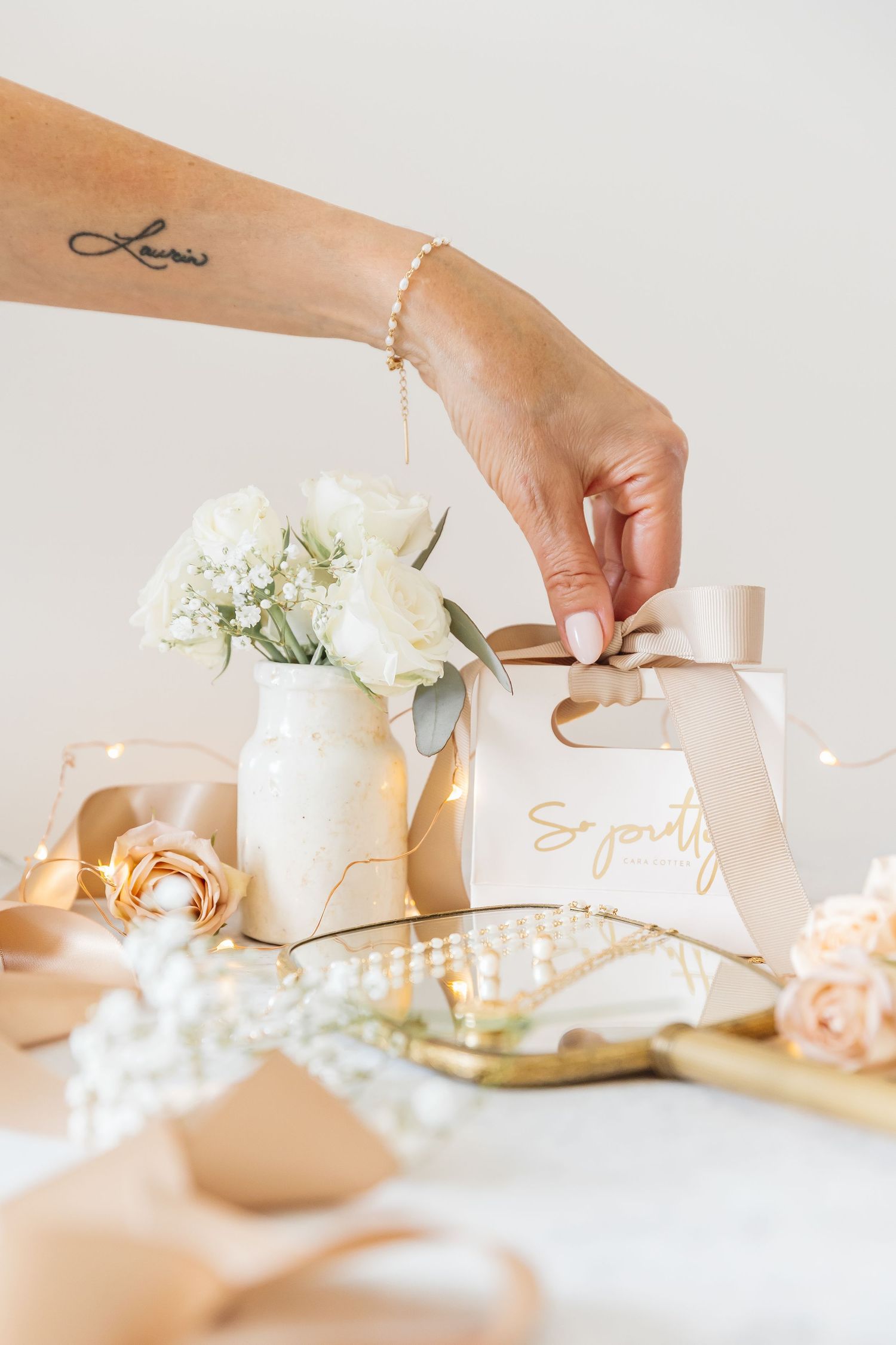 Styled indoor lifestyle branding photoshoot of jewelry and flowers photographed by a West Kelowna photographer