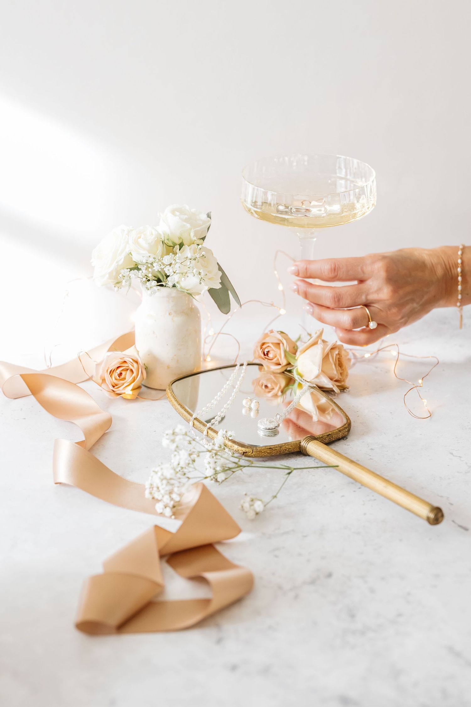 Styled indoor lifestyle branding photoshoot of jewelry and flowers photographed by a Kelowna photographer