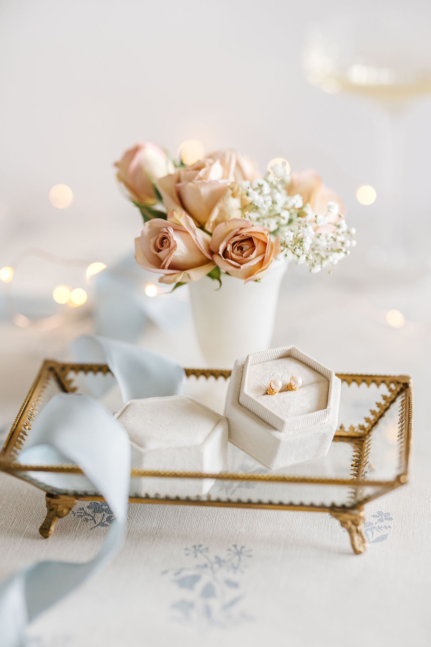 Blush pink roses and baby's breath in white vase with gold tray and jewelry box during a styled lifestyle photoshoot in Kelowna BC