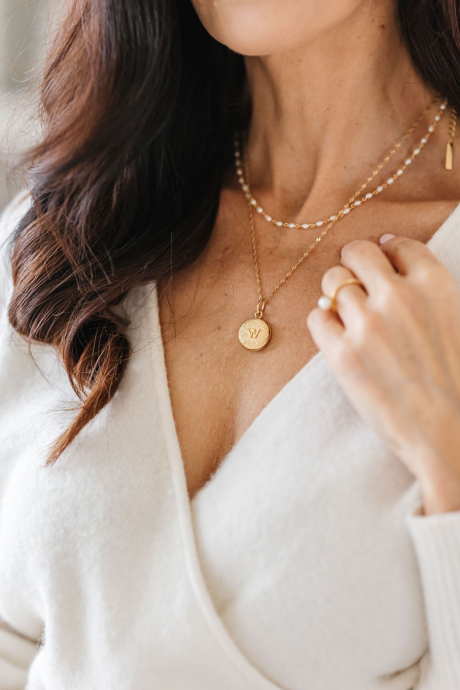 Lifestyle branding photographer in Kelowna, BC photographing a gold necklace close up