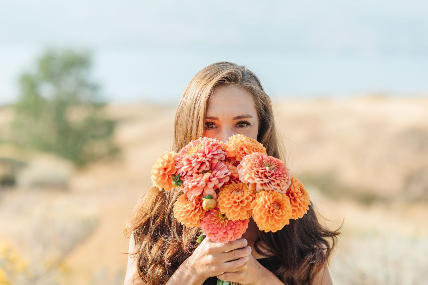 A collection of floral portraits showing models wearing vibrant orange and coral flower crowns in outdoor settings.