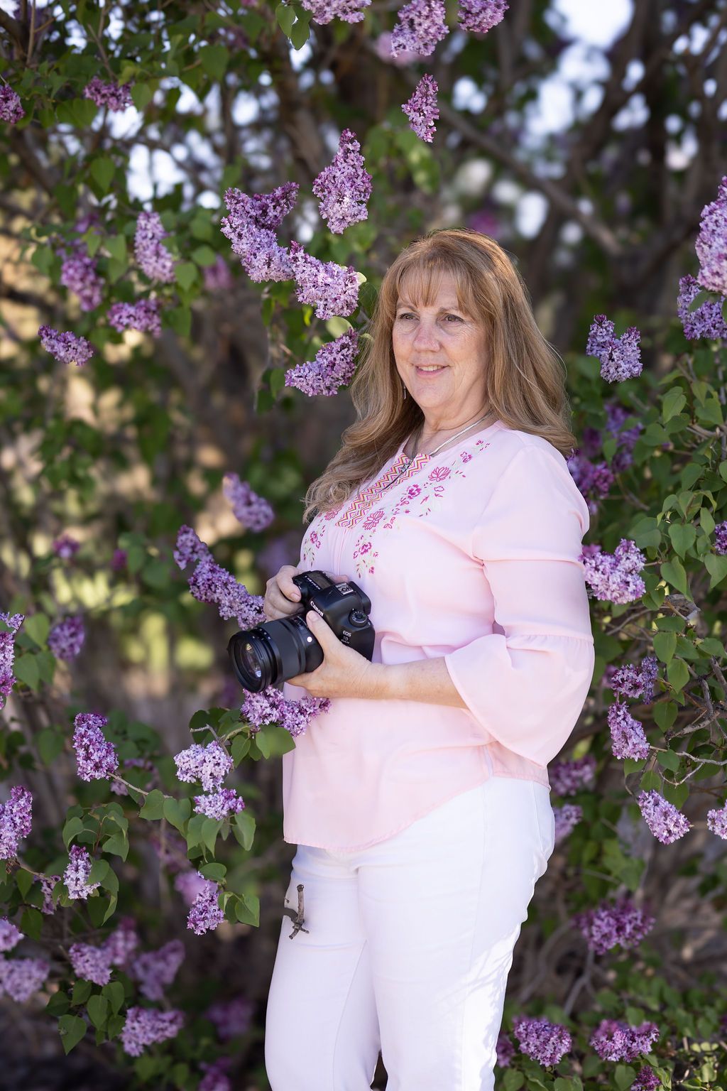 Lisa Craig - Lisa Craig Photography, a headshot, branding photographer & senior portrait photographer, poses with her camera