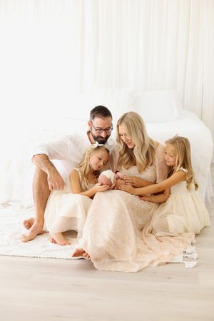 family snuggling baby girl