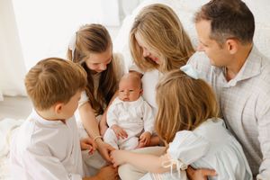 family looking at newborn baby
