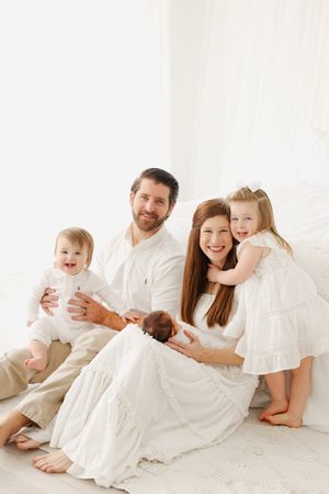 Family snuggling on floor