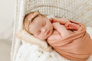 baby girl in wicker chair