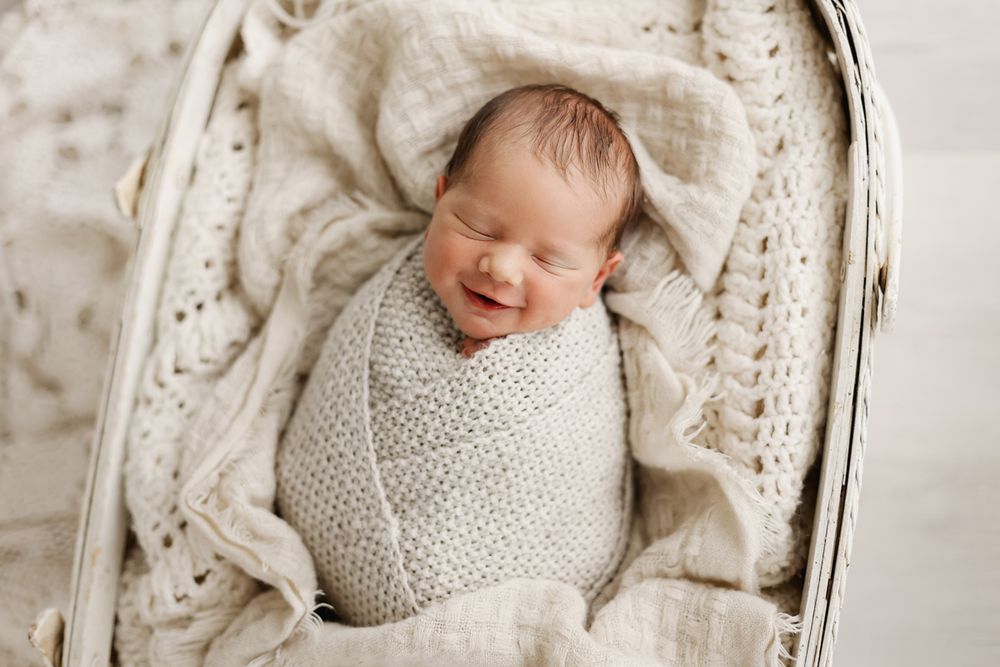 Baby boy smiling in a basket