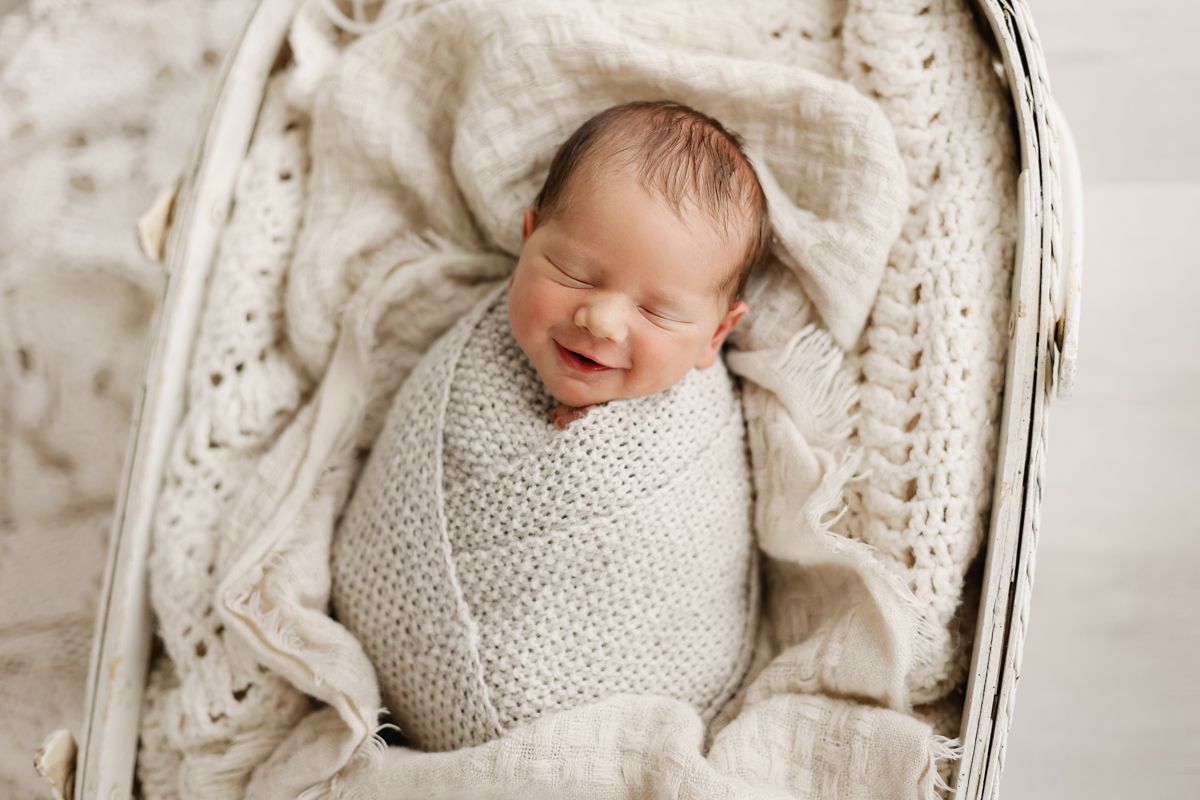 Baby boy smiling in a basket