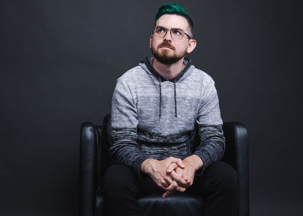 Studio portrait series showing seated figure against dark backdrop.