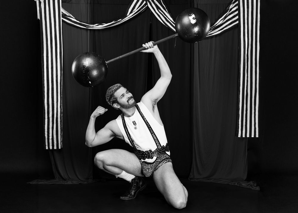 Dramatic black and white photos with striped backdrop featuring retro cabaret style poses.