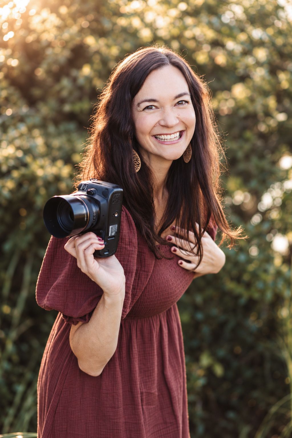 Portrait series of someone wearing a plaid flannel shirt and burgundy top against a mountain backdrop.