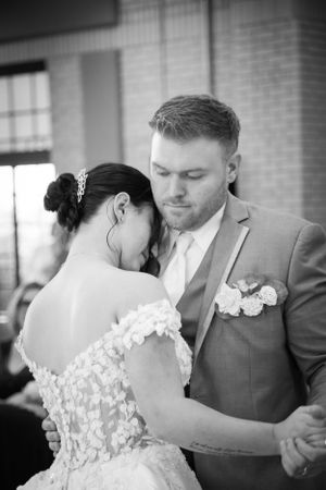 Black and white intimate dance moment at wedding reception.