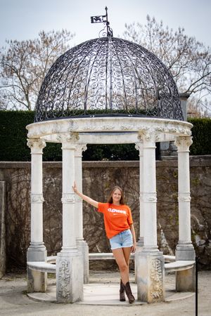 A series of photos showing a decorative stone gazebo with ornate metalwork dome and white columns at a garden wall.