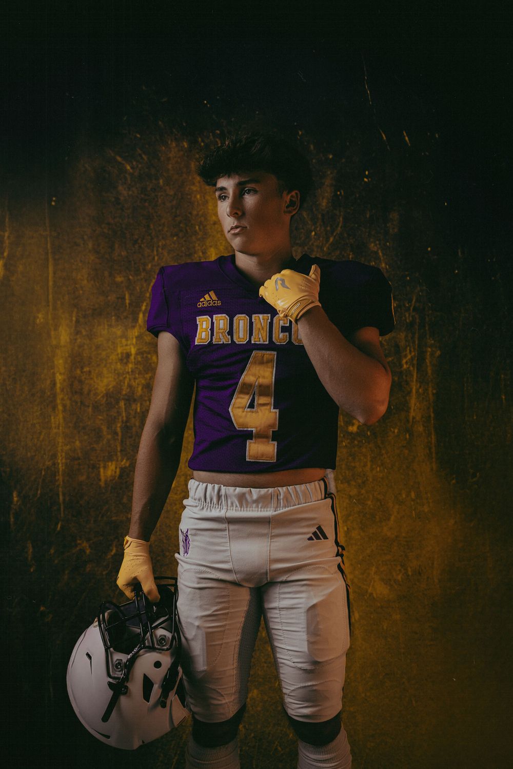 Senior sports photography in Kansas featuring dynamic posing and team gear
