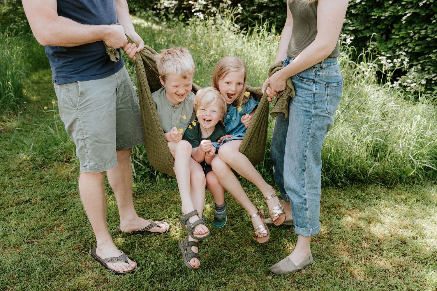 Children playing together outdoors in a natural setting during summer.