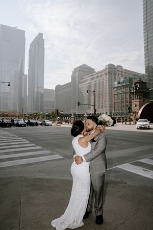 A sequence of four romantic wedding photos showing a couple dancing in front of a misty city skyline.