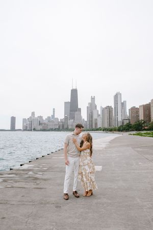 A couple strolls along Chicago's North Avenue beach with the iconic skyline in the background across multiple candid photos.