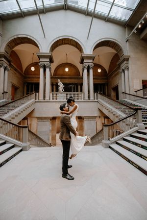 A sequence of photos showing a couple dancing in an elegant arched hallway with marble stairs and classical architecture.