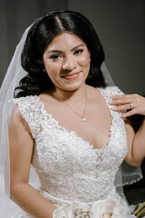Close-up details of a white lace wedding dress with delicate embroidery and sweetheart neckline.