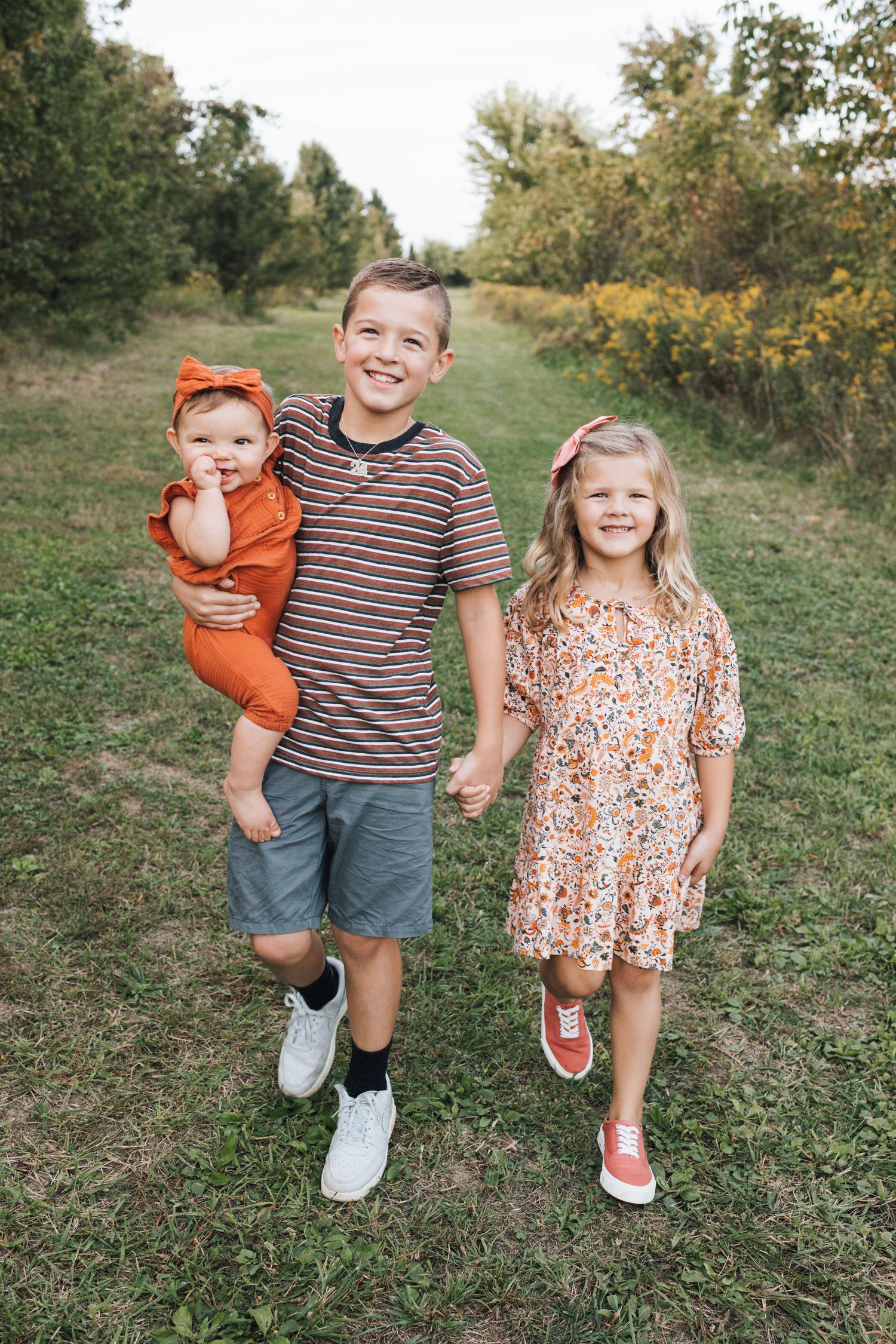 Sibling walking together through a flower field